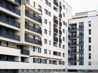 Architectural details of modern multi-leveled apartment building with balconies and lodges