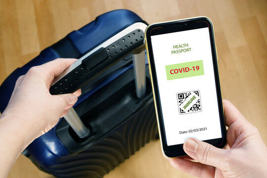 Vaccination passport on a mobile phone allowing travel in hand. Vaccination against the coronavirus Covid 19.Imunity or Health passport
