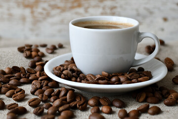 Coffee cup and a scattering of coffee beans