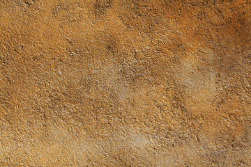 Roughly plastered wall. Orange textured background