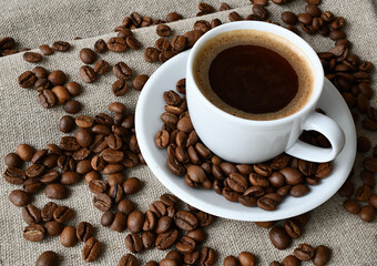 Coffee cup and a scattering of coffee beans