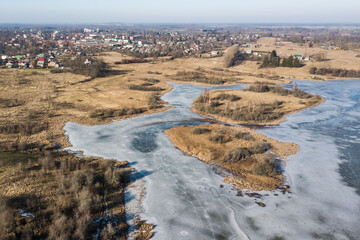 Aerial view of frozen water reservoir with islands, Aizpute, Latvia.