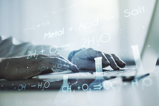 Double exposure of creative chemistry concept with hands typing on laptop on background, research and development concept