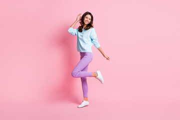 Full length body size view of attractive cheerful skinny wavy-haired girl jumping having fun isolated over pink pastel color background