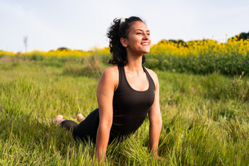 girl does a yoga posture in nature