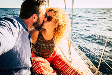 Adult beautiful married couple kissing on the yacht on vacation - romantic travel tour excursion...