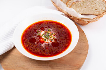 red soup with sour cream and greens