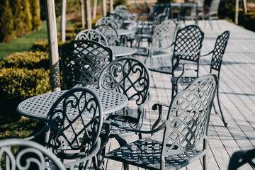 Wrought iron table and chairs at a cafe terrace.