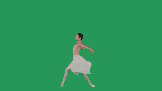 Elegant ballerina dancing classical ballet on green screen.