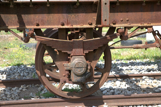 wagon wheels , old train, old wagon ,in an abandoned station.