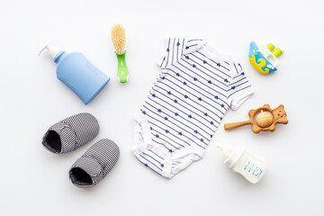 Baby accessories with bodysuit and shoes. Flat lay