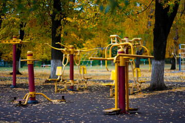 Fototapeta premium Workout fitness facility playground with metal sports equipment outdoors on a nice autumn or fall day
