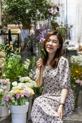 Startup successful small business entrepreneur owner young asian woman standing with flowers at florist shop