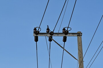 Viewed from under the small electric pole there are important devices such as pin-type insulators, fog-type insulators, and wires to transmit electricity to village users.
