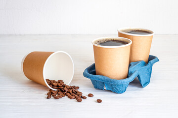 Black coffee in paper cups with beans. Take away coffee background