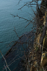 Gorgeous beautiful seascape view from the forest mountain. Walk over the abyss. View from a high cliff to the blue turquoise clear sea and coral reefs under the water.