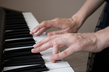Close-up of the woman hand On Digital Piano Keyboard.