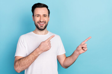 Portrait of attractive cheerful guy showing copy empty space way direction offer isolated over blue bright pastel color background
