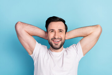 Fototapeta na wymiar Close-up portrait of attractive cheerful glad guy resting looking up isolated over blue bright pastel color background
