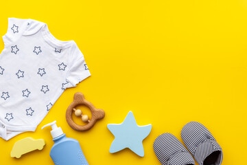 Baby boy bodysuit and shoes with toys. Flat lay
