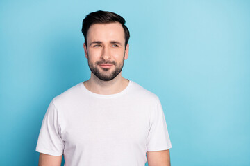 Portrait of attractive minded cheery suspicious guy wearing white tshirt thinking copy space isolated over blue bright pastel color background