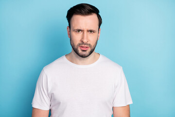 Portrait of attractive moody discontent suspicious guy wearing white tshirt isolated over blue bright pastel color background