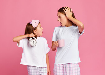 Astonished mother and daughter being late in morning