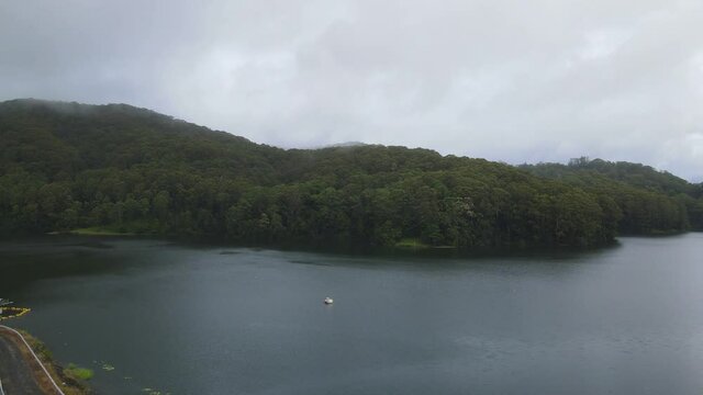 Drone Reveal Of Calm Water At Karangi Dam In An Overcast Weather. Reservoir In Orara Valley, Karangi, Coffs Harbour. aerial ascend