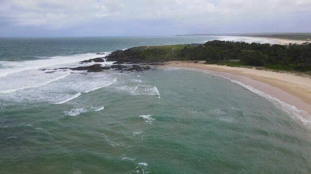 Peaceful Ocean With Waves Splashing On Sandy Shore. Bonville Headland In Sawtell, NSW, Australia. aerial drone