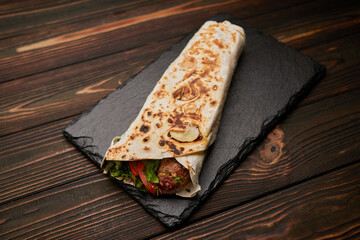 Lula kebab in pita bread with herbs tomato
