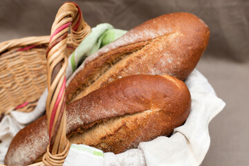 Rye flour bread lies in a straw basket