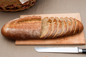 The bread is cut into pieces and lies on a wooden board on the table