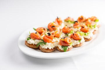 Canape with red fish and cheese on a white background