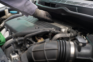 Fototapeta premium Mechanic man hand checking car engine oil