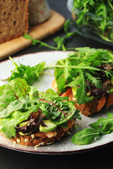 Sandwiches with salmon, avocado and salad