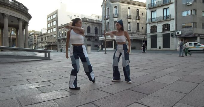 Two girls practicing artistic dance in an old city