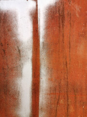 old red metal wall with corrosion and rust stained with white paint