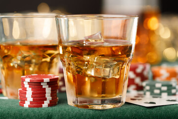 Cards, playing chips and alcohol in glass