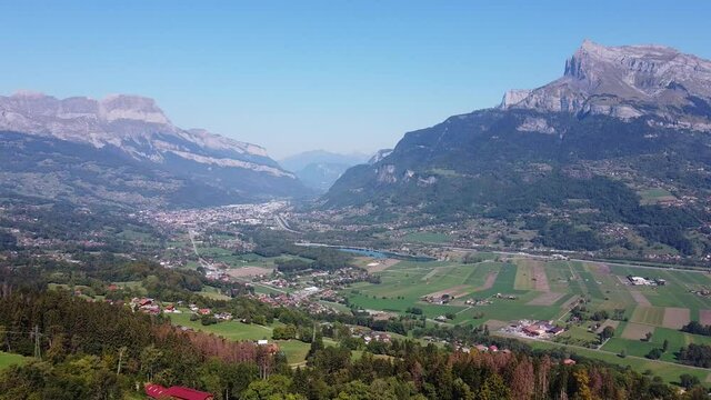 Flying towards a populated valley in the french Alps. Arve valley, Haute Savoie, France.