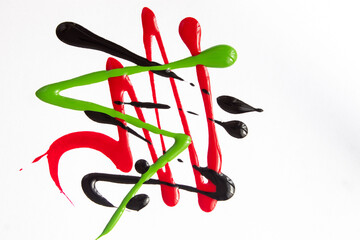 black and red liquid nail polish poured out onto a white backdrop without any applicator and container