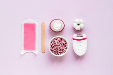 Cosmetics and means for epilation with flowers on pink background, flat lay