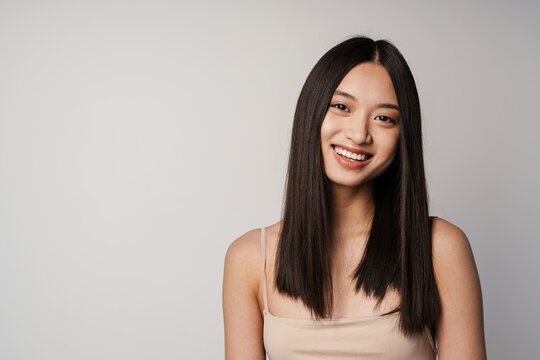 Young asian happy woman smiling and looking at camera