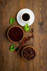 Cup of espresso coffee beans and ground powder, top view