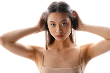 Young asian brunette woman posing and looking at camera