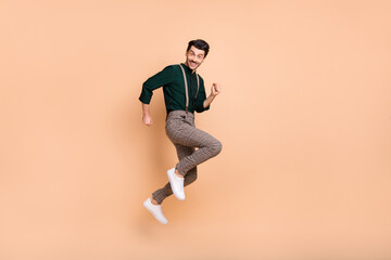 Fototapeta na wymiar Full size profile side photo of charming funky man jump up air runner empty space sale isolated on beige color background