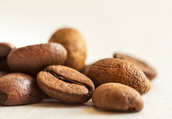Roasted coffee beans, on a white background. Selective focus. Macro