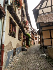 The picturesque streets of Eguisheim, Alsace. Central square with the fountain in Eguisheim. France. 