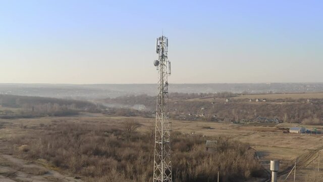 Mobile cell tower in rural areas on the ground of the horizon - telecom station of cellular communication. Cellular tower 4G and 5G, providing work of mobile operators in rural area. 