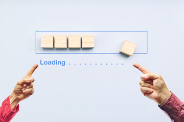 Pointing progress bar filling with wooden cubes. Loading status