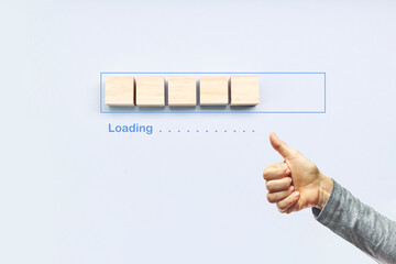 Ok gesture next to the progress bar filling with wooden cubes. Loading